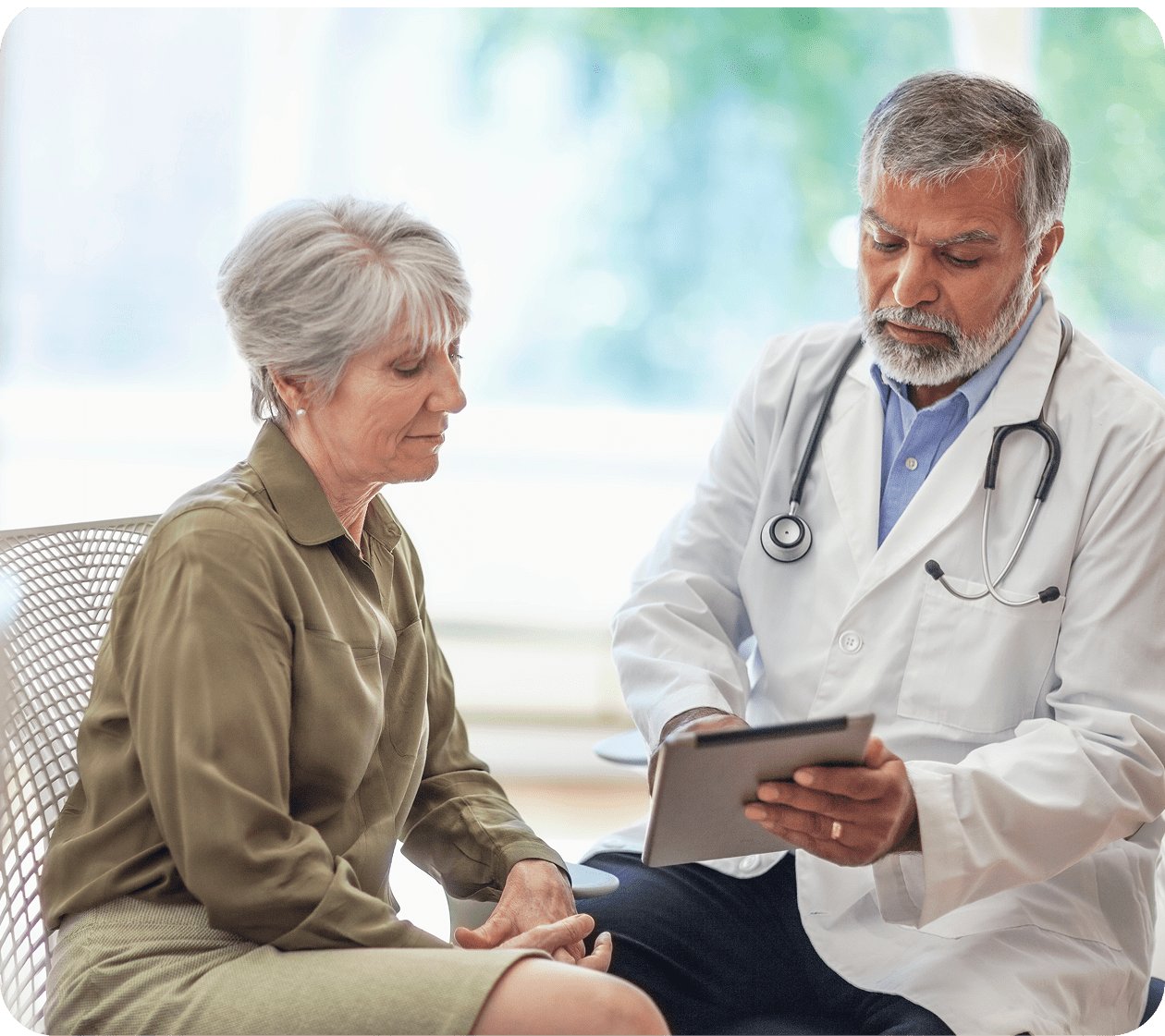Doctor discussing health with an elderly woman.