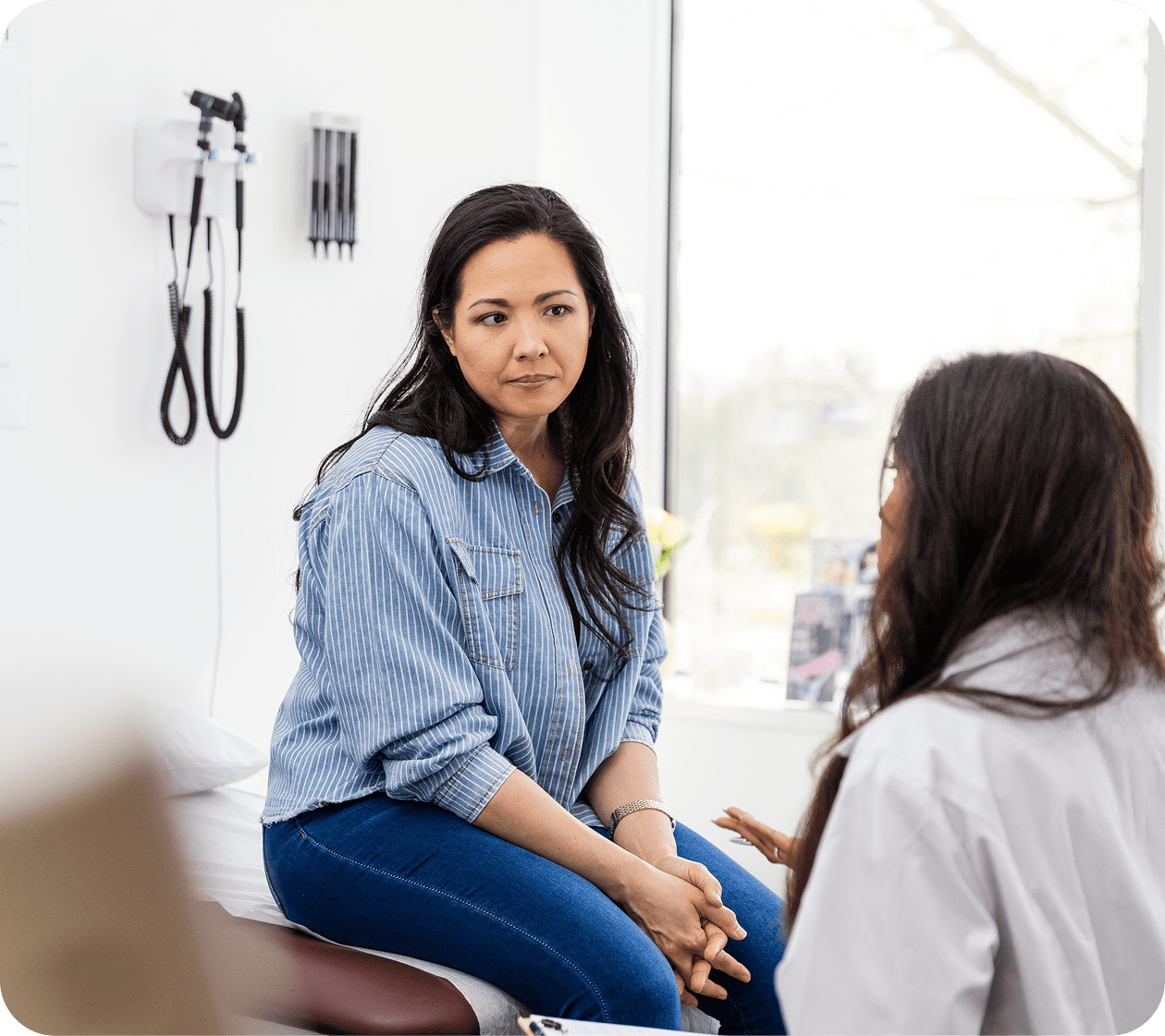 A woman consulting with a healthcare professional in a clinic.