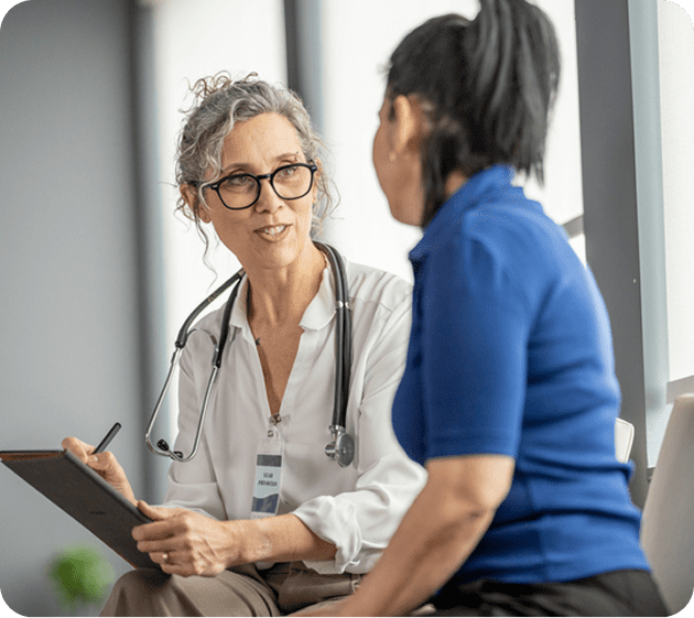 Female doctor attentively listening to a patient during consultation.