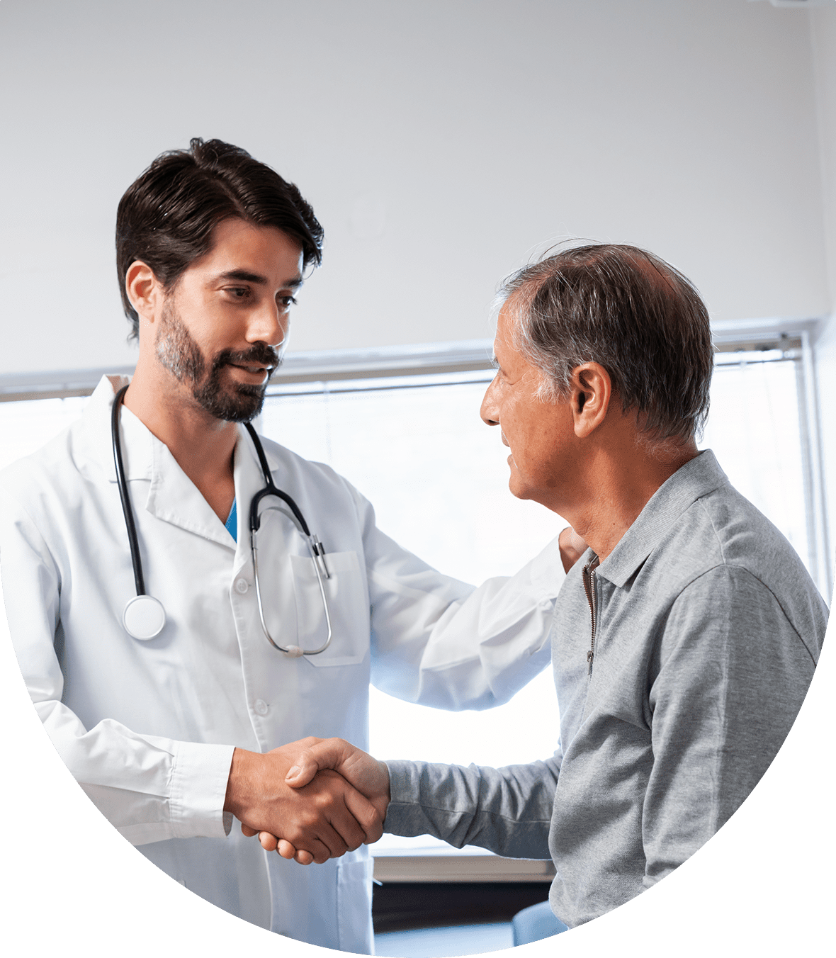 Doctor shaking hands with an elderly patient in a clinic.
