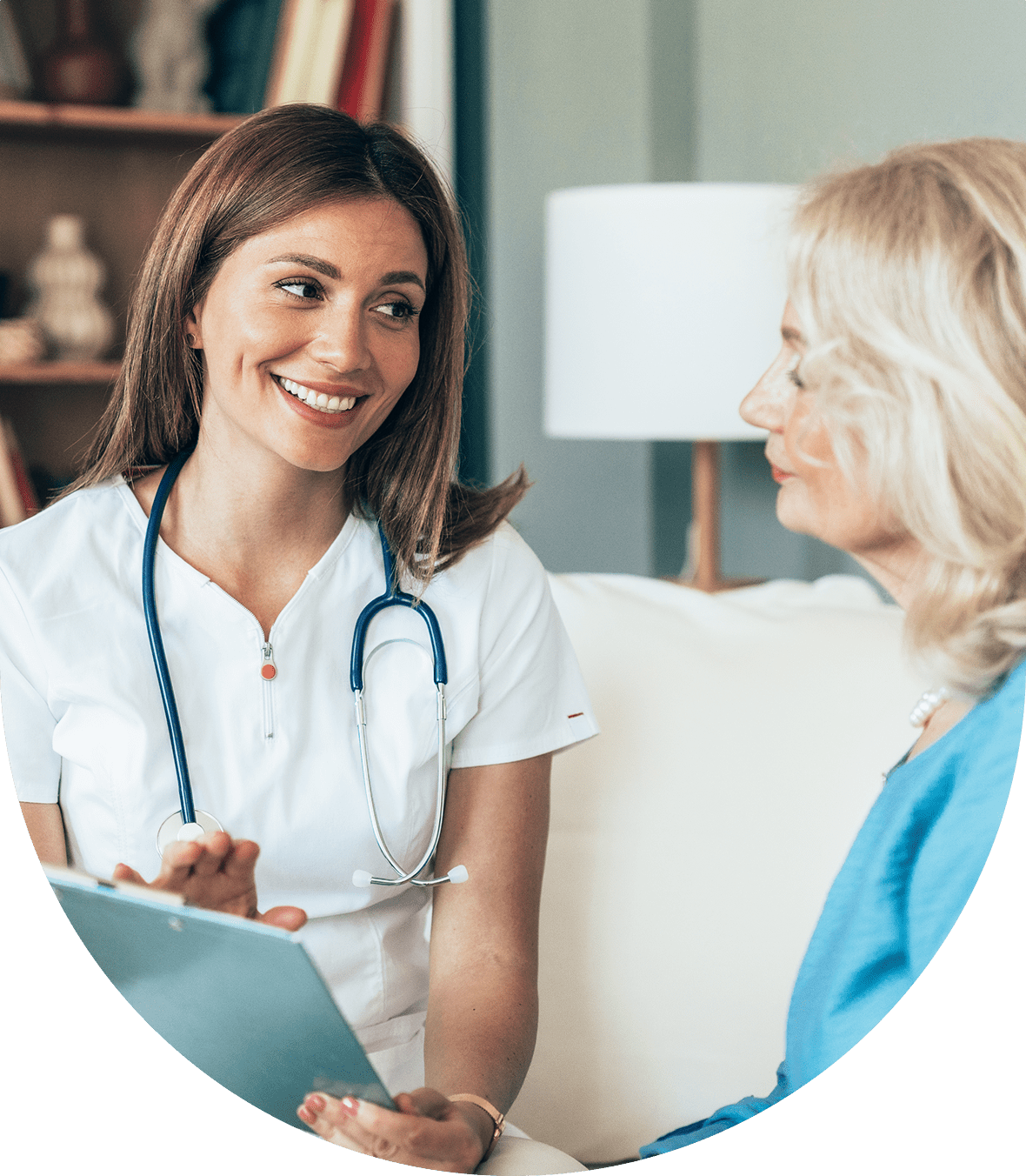 A female doctor consulting with a female patient in a cozy setting.