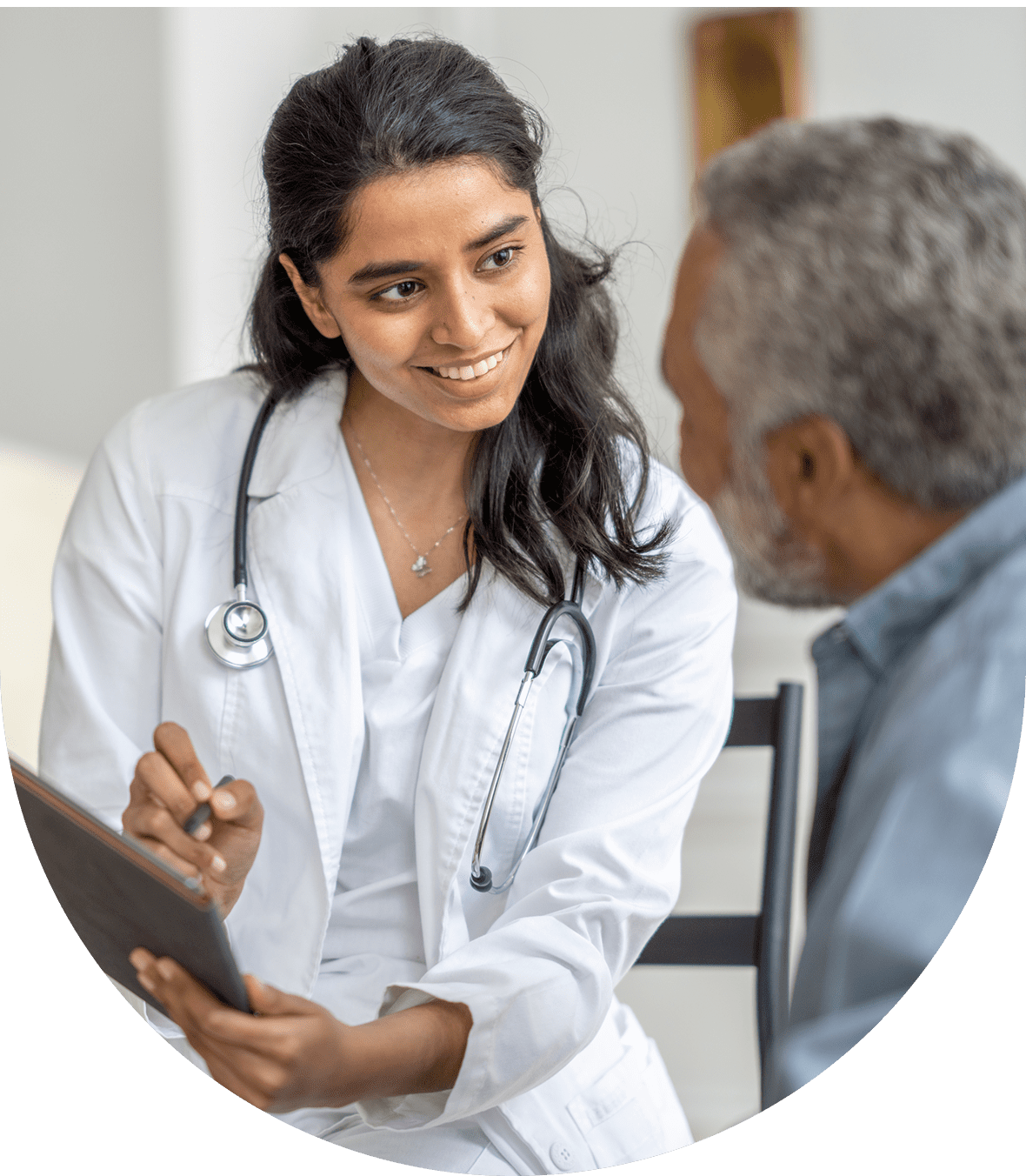 A doctor consulting with an elderly patient, showing attentiveness and care.