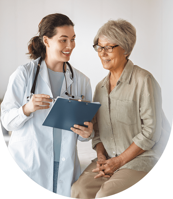 Doctor consulting with elderly female patient during appointment.